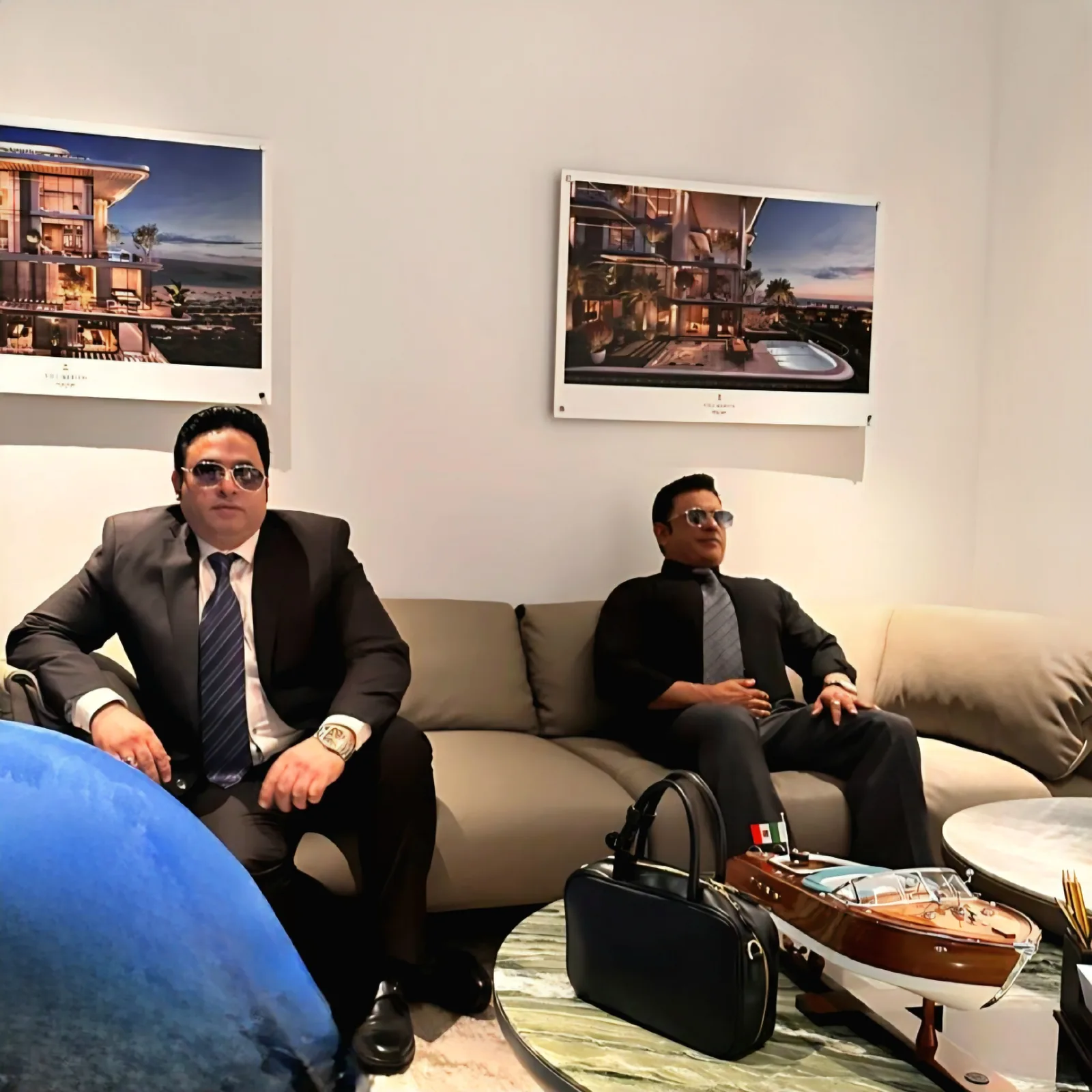 AlixirNova team members at a luxury Dubai villa sales lounge with project renderings on display